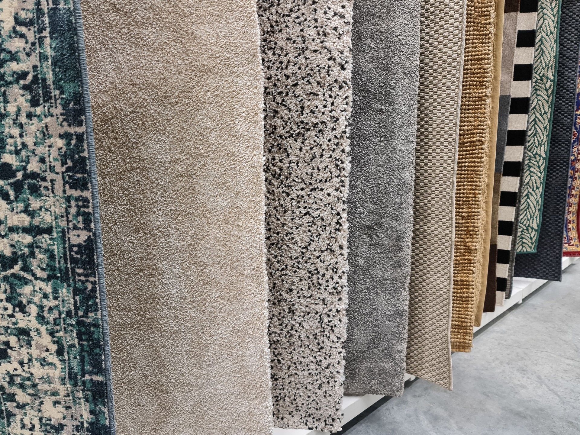 Different colorful carpets in a store