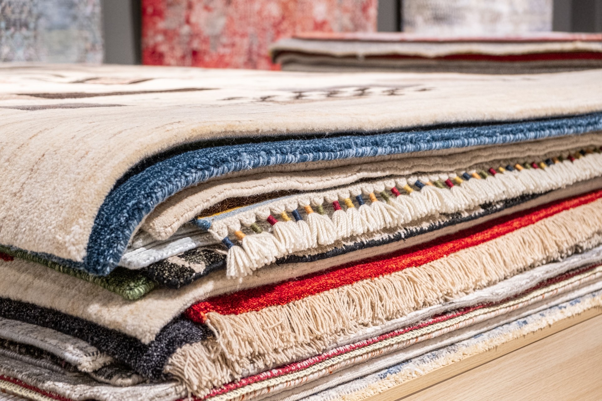 Various west style carpets are arranged in a row in a store, showcasing different textures and patterns that enhance interior design options